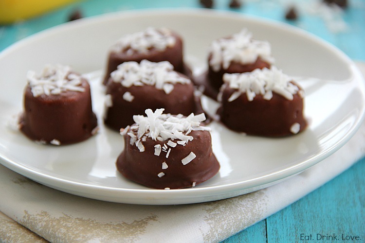 Chocolate-Covered Banana slices with shredded coconut on top on a white plate