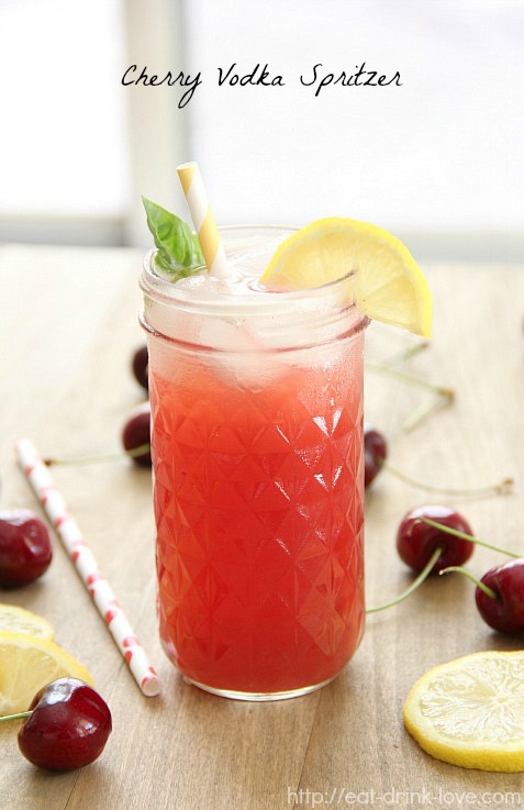 Cherry Vodka Spritzer in a glass jar with cherries and a straw