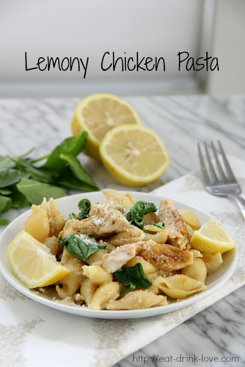 Lemony Chicken Pasta on a white plate with lemon slices