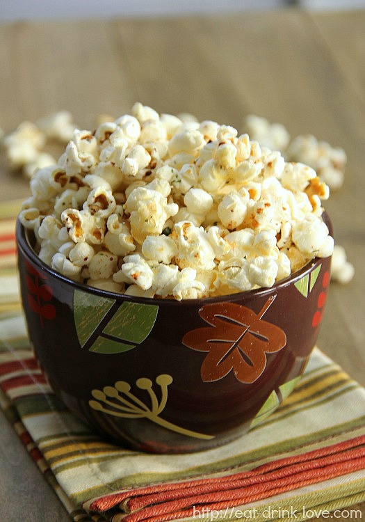 Parmesan Ranch Popcorn in a brown bowl with a striped napkin