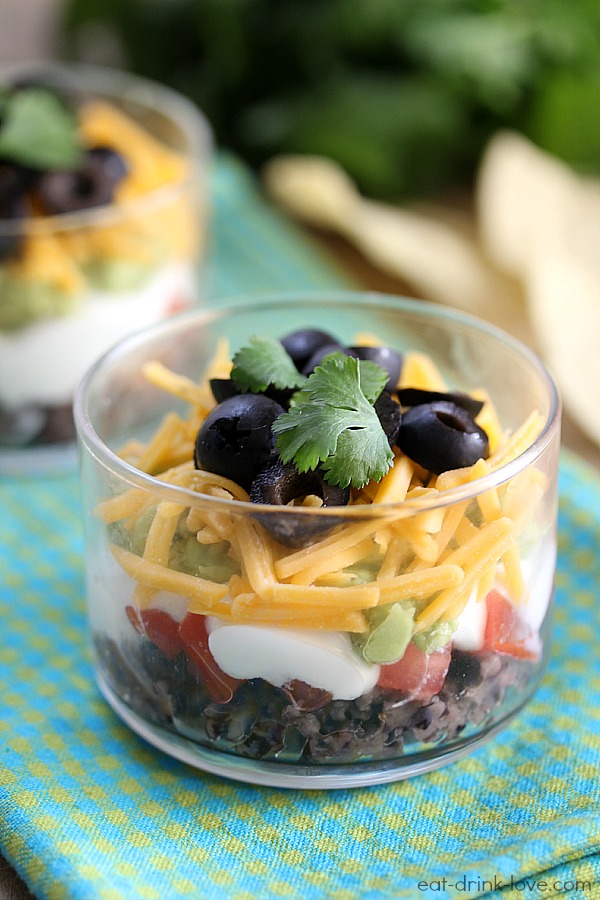 Skinny Taco Dip Cups in a glass serving cup with cilantro on top