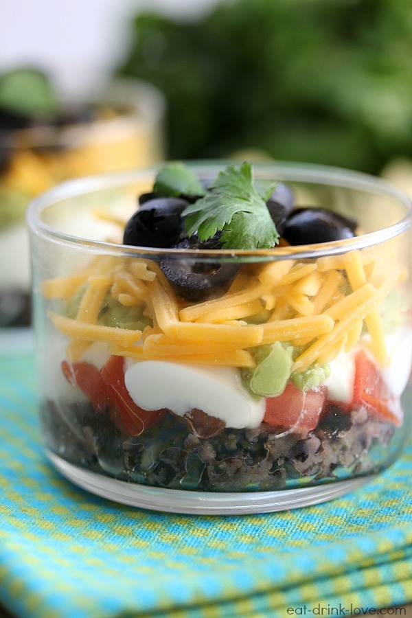 Skinny Taco Dip Cups in a glass serving cup with cilantro on top