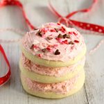 Sugar Cookies with Vanilla Bean Frosting - stacked sugar cookies with pink frosting and heart sprinkles