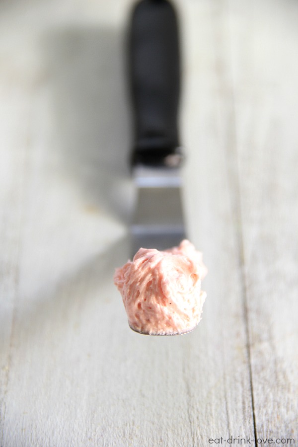 Pink Vanilla Buttercream Frosting on a knife