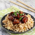 Lightened Up General Tso's Chicken on a plate with a green napkin