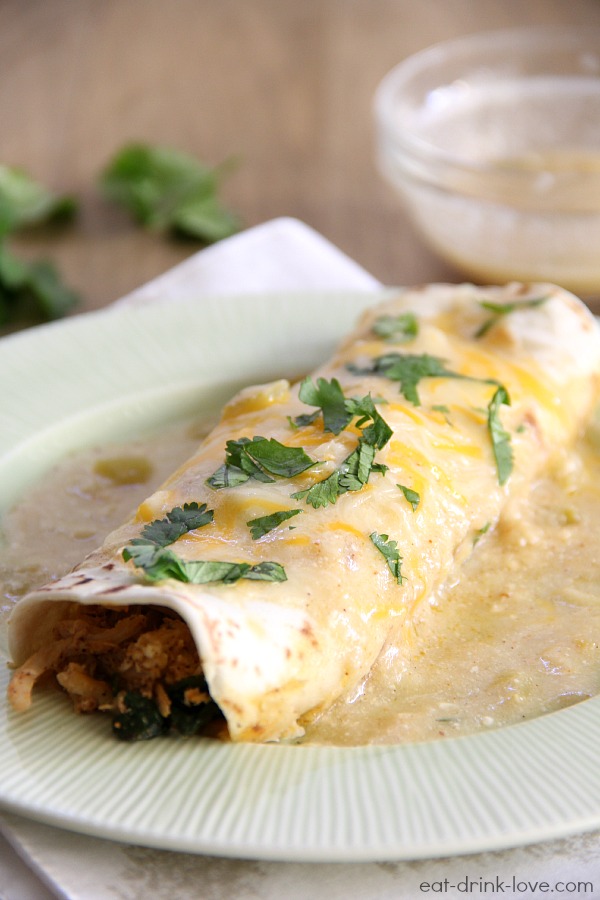 White Chicken and Spinach Enchiladas on a green plate