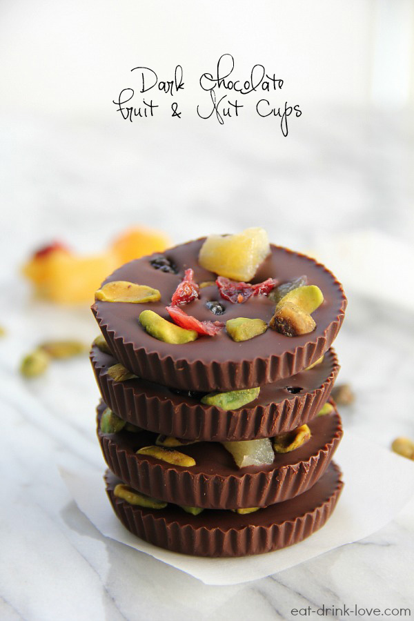 Dark Chocolate Fruit and Nut Cups stacked on a white marble board