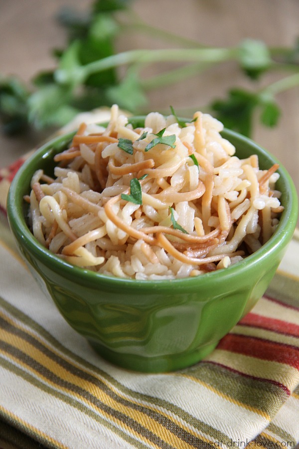 Easy Rice Pilaf in a green bowl with a striped napkin