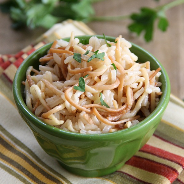 Easy Rice Pilaf in a green bowl with a striped napkin