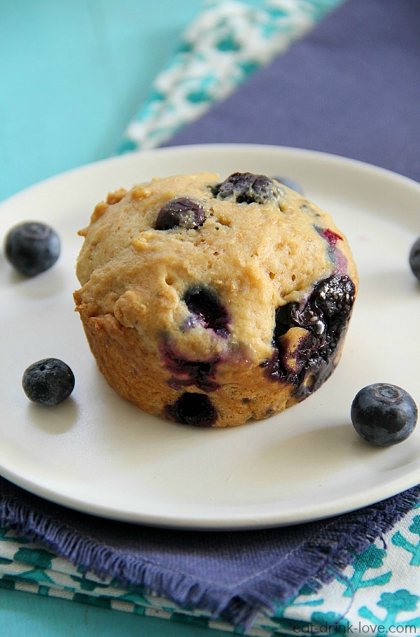 Skinny Blueberry Muffins on a plate with purple and blue napkins