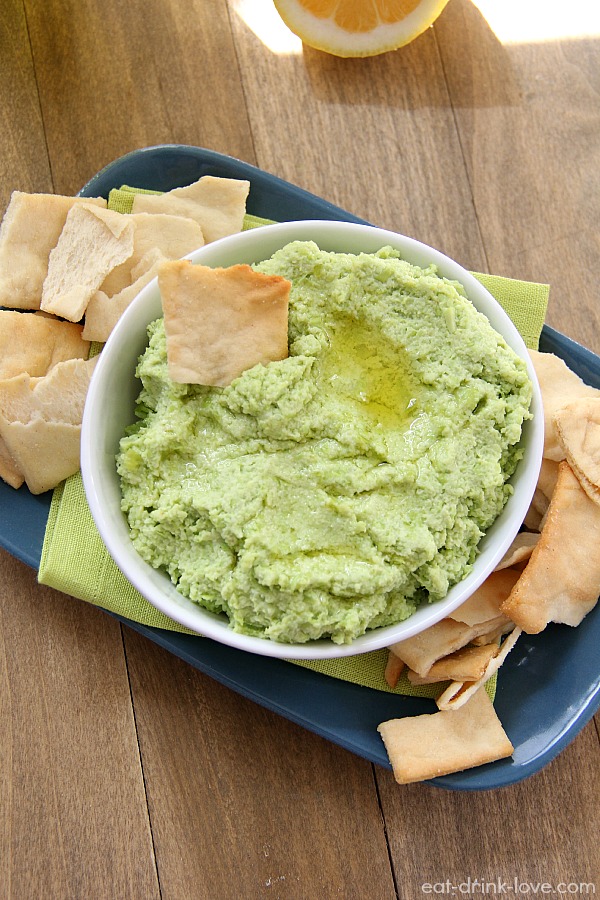 Easy Edamame Dip in a white bowl with pita chips