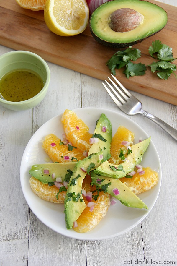 Overhead shot of Citrus Avocado Salad on a white plate with avocado