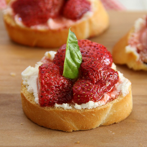 Roasted Balsamic Strawberry and Goat Cheese Crostini on a wooden board