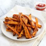Zesty Baked Sweet Potato Fries on a white plate