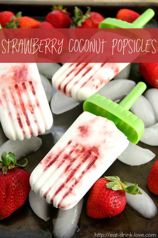 Strawberry Coconut Popsicles on ice with strawberries