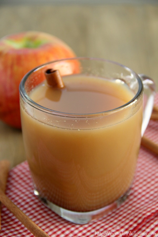 Spiced Apple Cider in a glass mug on a red checkered napkin