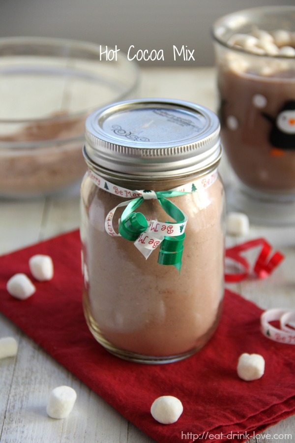 Hot Cocoa mix in a glass jar on red napkin with a green ribbon