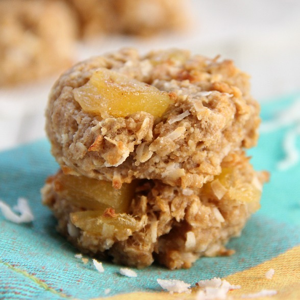 Tropical Breakfast Cookies stacked with dried pineapple and mango on a teal napkin