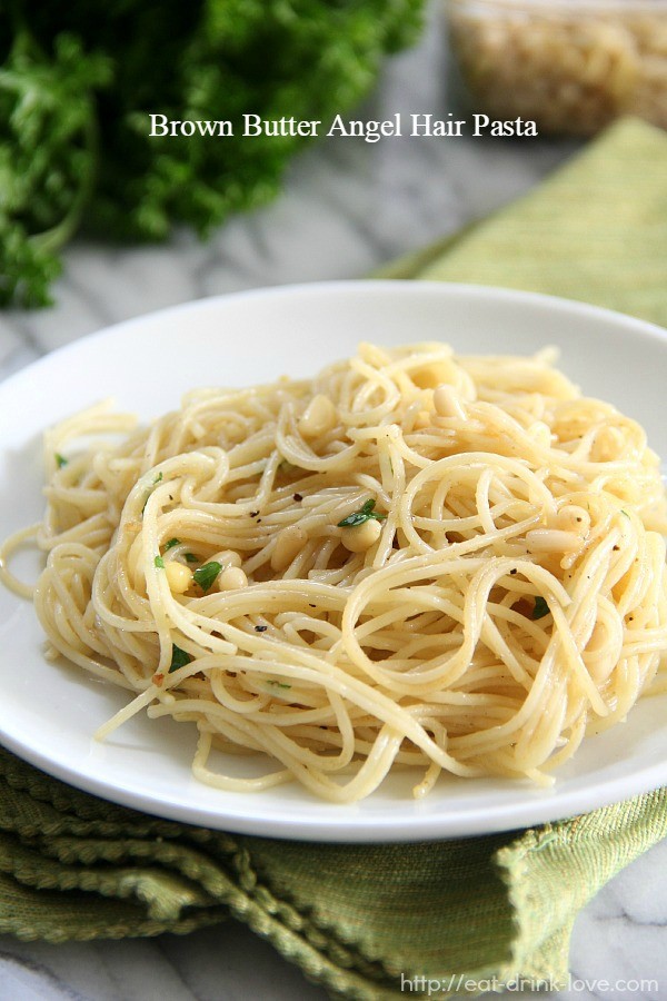Browned Butter Angel Hair Pasta - angel hair pasta on a plate with parsley and pine nuts