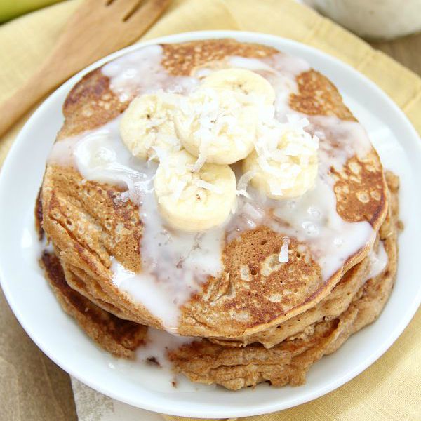 Whole Wheat Banana Pancakes with coconut syrup and banana slices