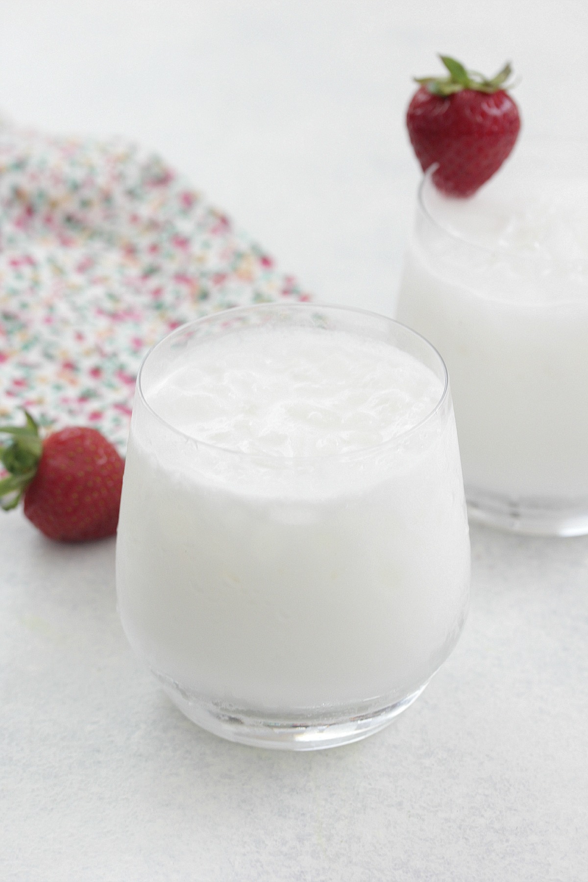 Coconut Coolers served in short glasses with sliced strawberries