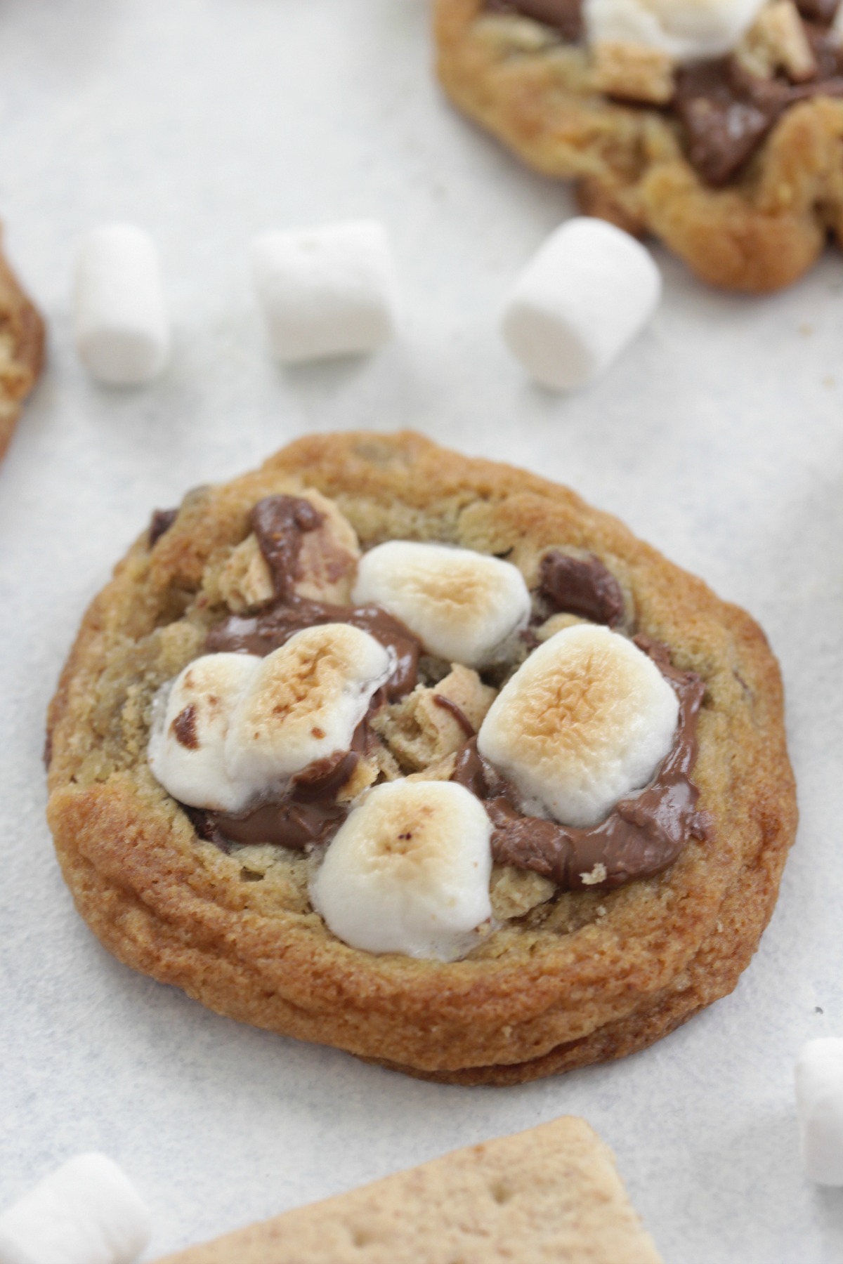 S'mores Cookies on a white board with mini marshmallows