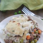Low-Carb Shepard's Pie on a plate with cauliflower topping, beef, carrots, and peas