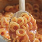 Homemade Spaghettios in a pot with wooden spoon