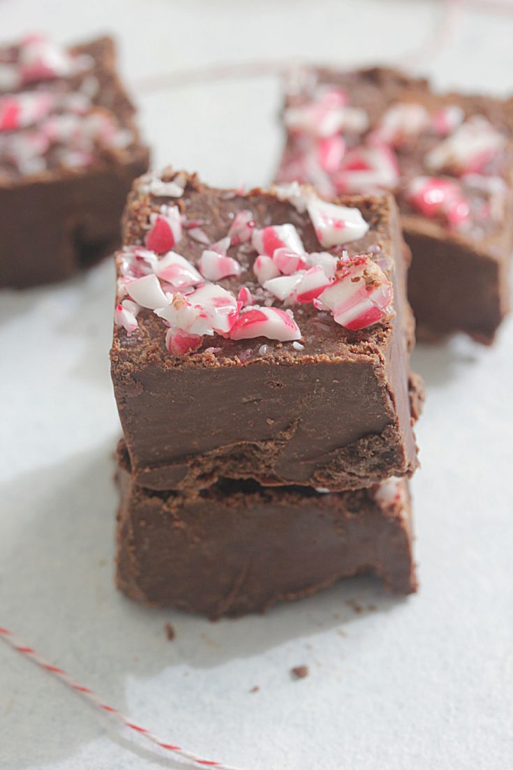 Peppermint Fudge stacked with crushed candy canes on top