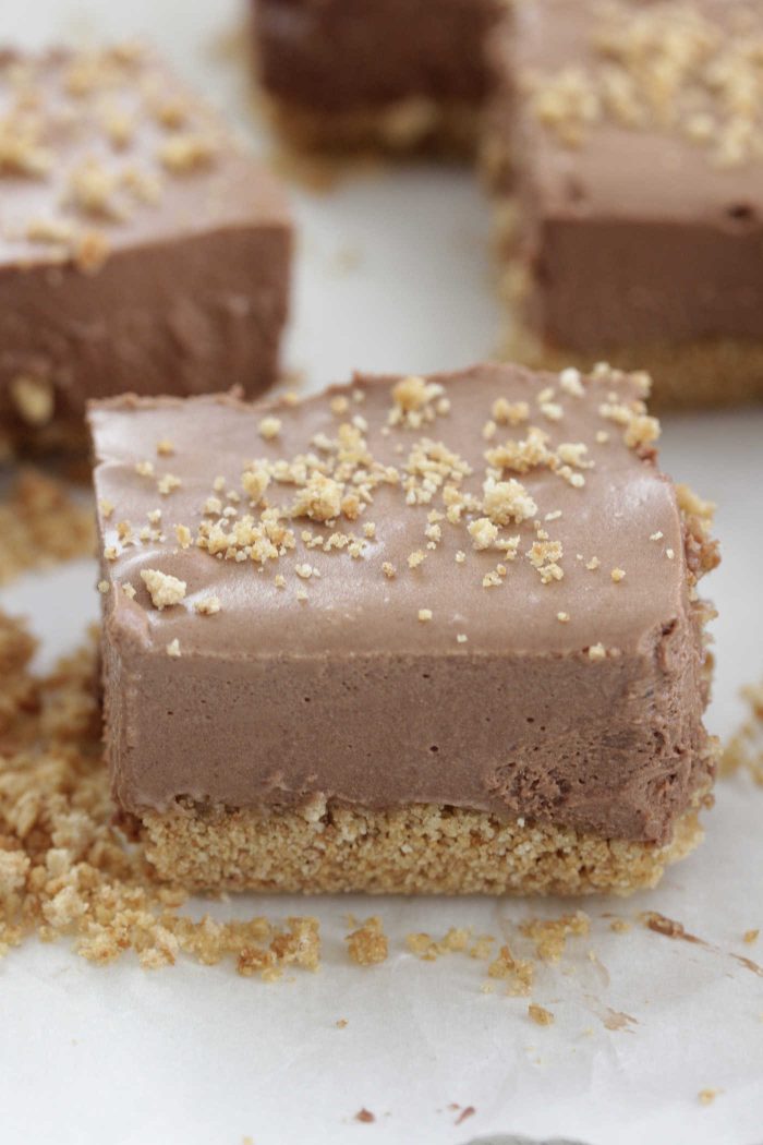 Chocolate Mousse Bars sliced on a white wooden board