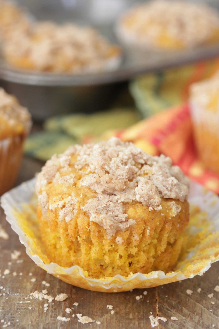 Apple Pumpkin Muffin on a peeled muffin wrapper with crumb topping