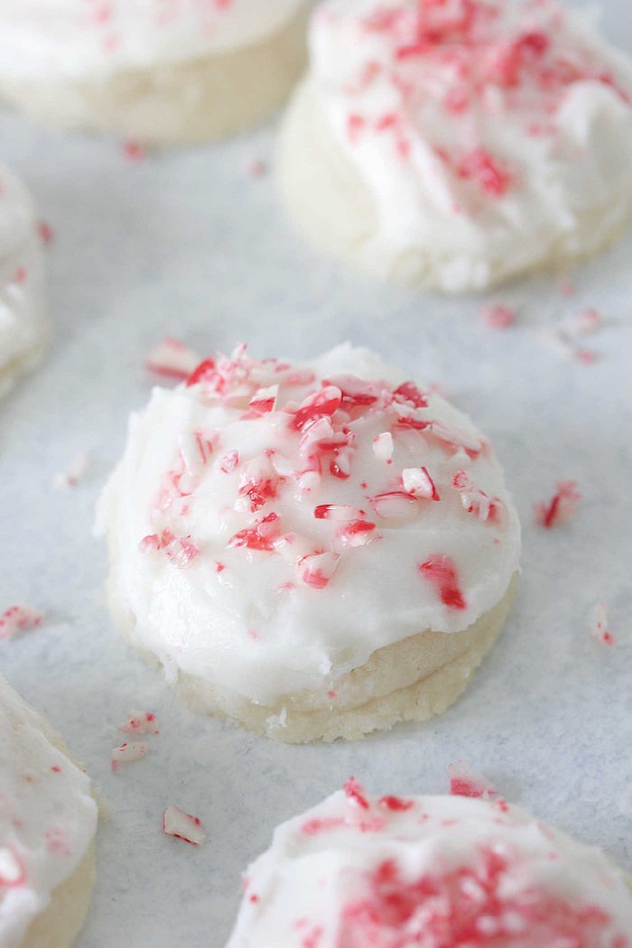Peppermint Meltaways on a white board with crushed candy canes
