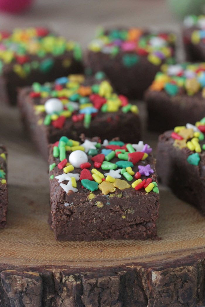 3 Ingredient Holiday Fudge on a board with sprinkles