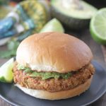 Mexican Pinto Bean Burgers on a blue plate with a lime wedge