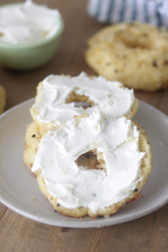 Low-Carb bagels with plain cream cheese spread on each half.