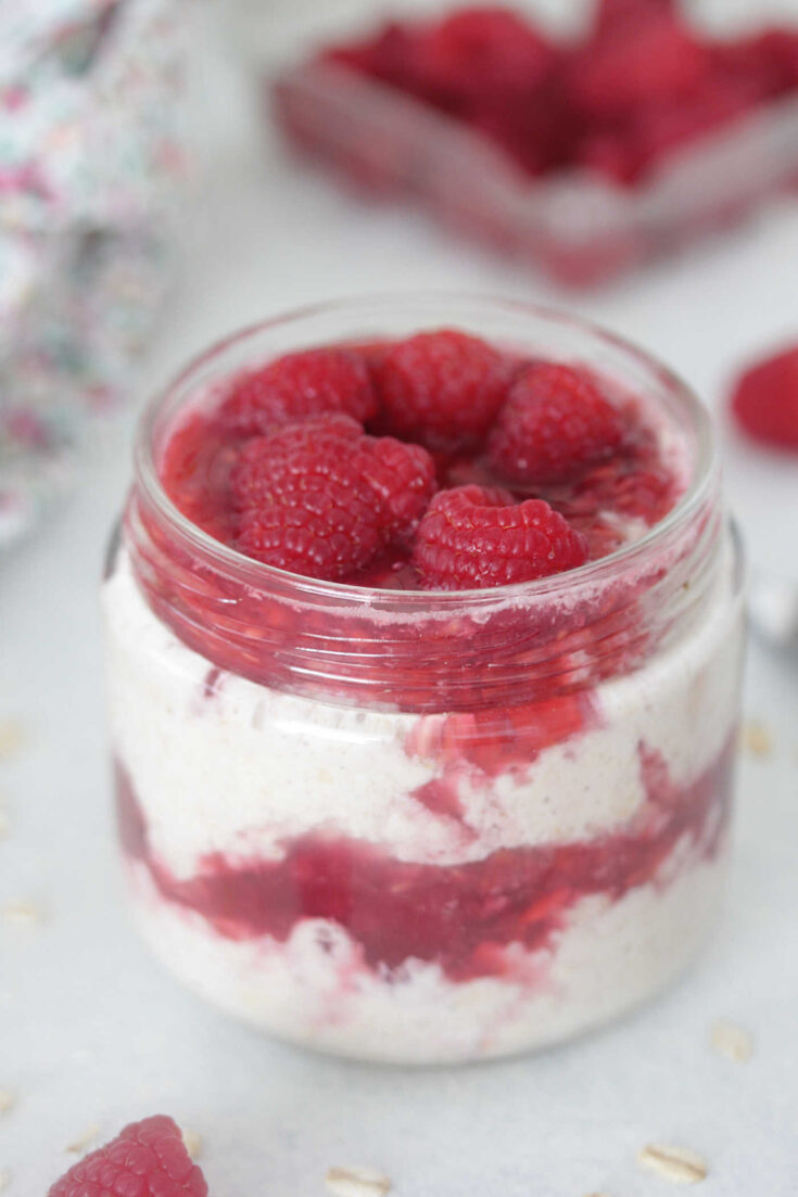 Raspberry Cheesecake Overnight Oats in a clear jar
