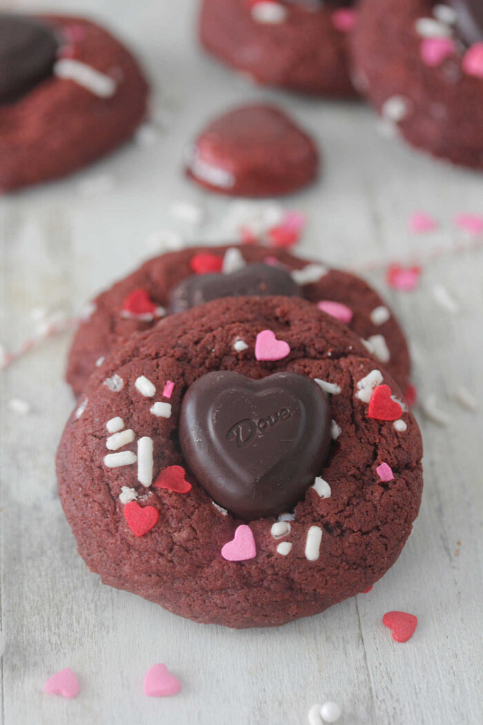 Red velvet cookies close up with dark chocolate heart and sprinkles on top