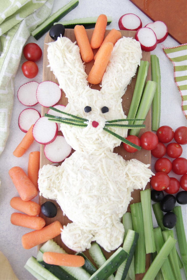 Easter Bunny shaped cheese ball with fresh vegetables on the side