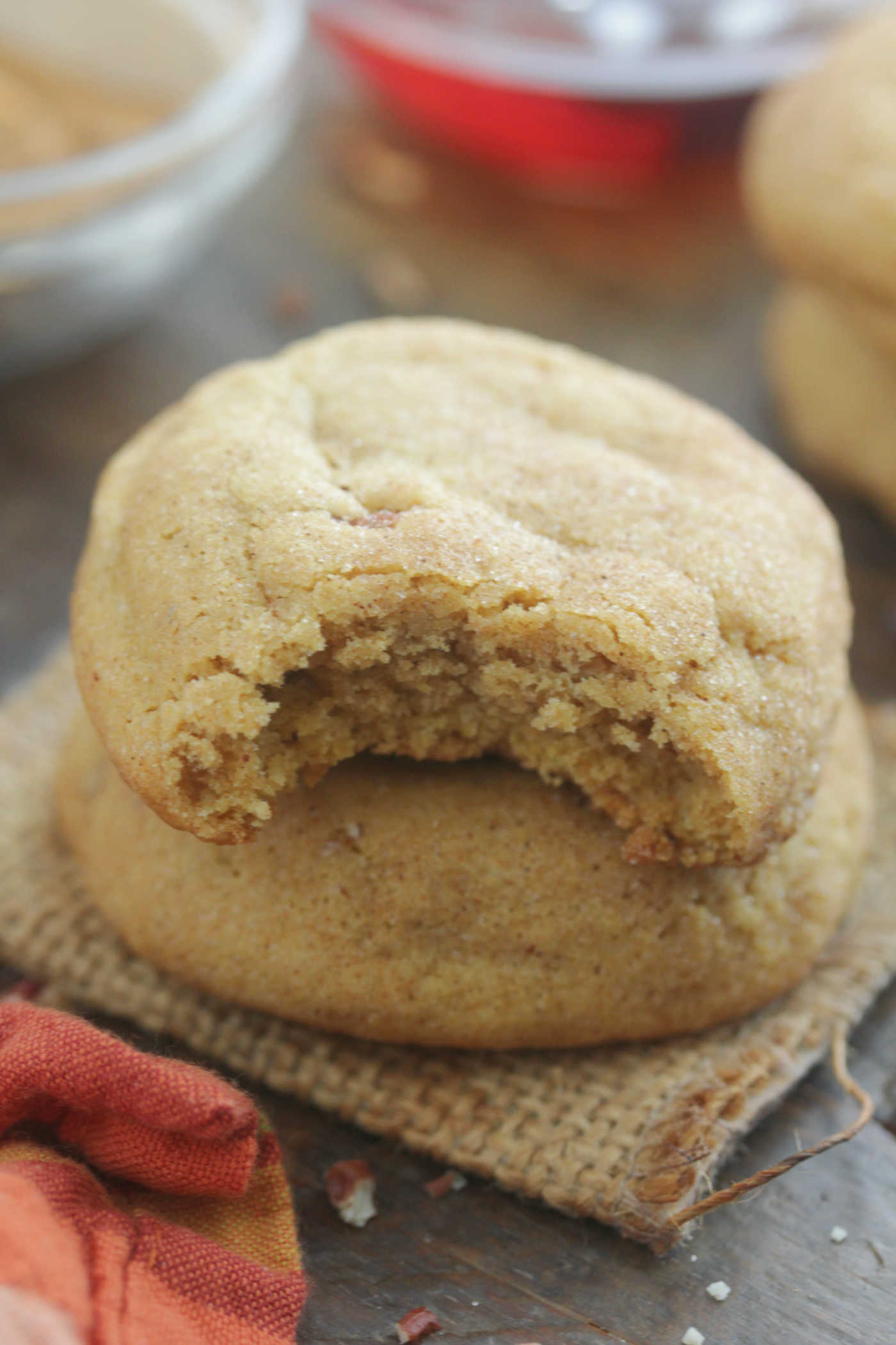 Brown Butter Maple Pecan Pumpkin cookies stacked with a bite taken out of the top one