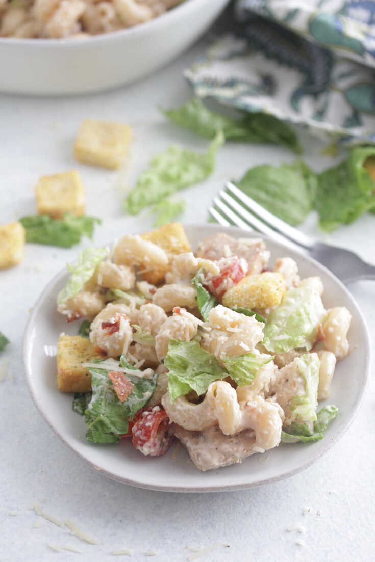 Angled photo of chicken caesar pasta salad on a plate